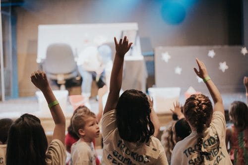 Youth raising hands during church service at The Rock Church, USA.